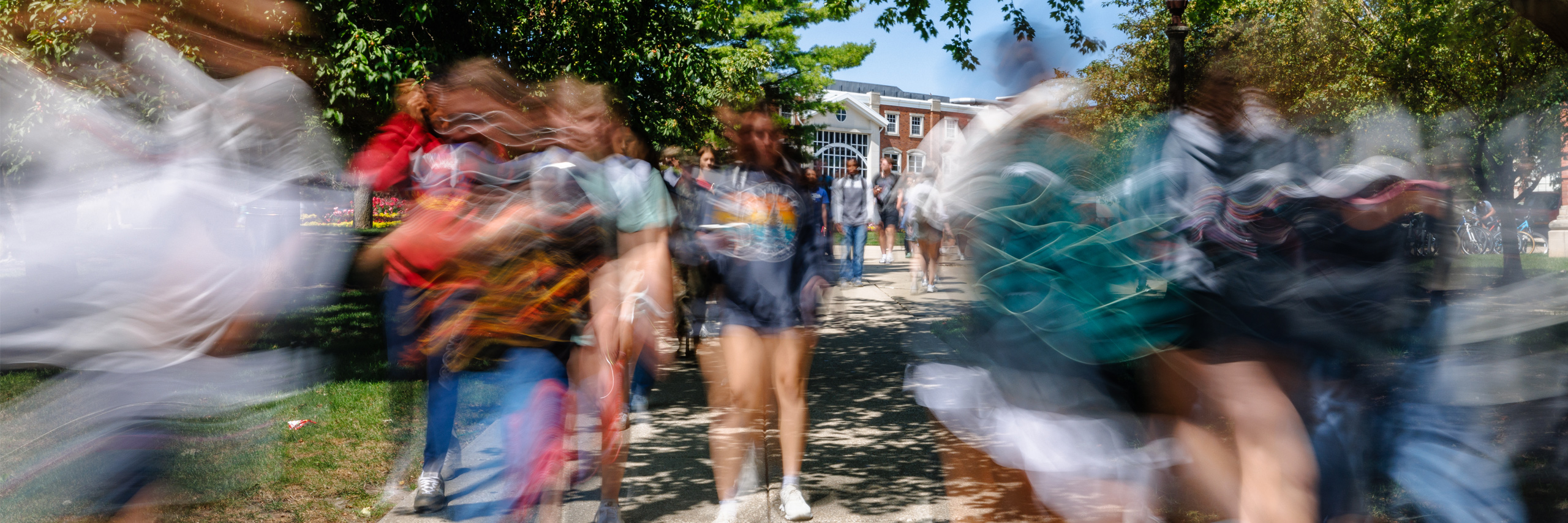 Stylized photo of students walking on quad