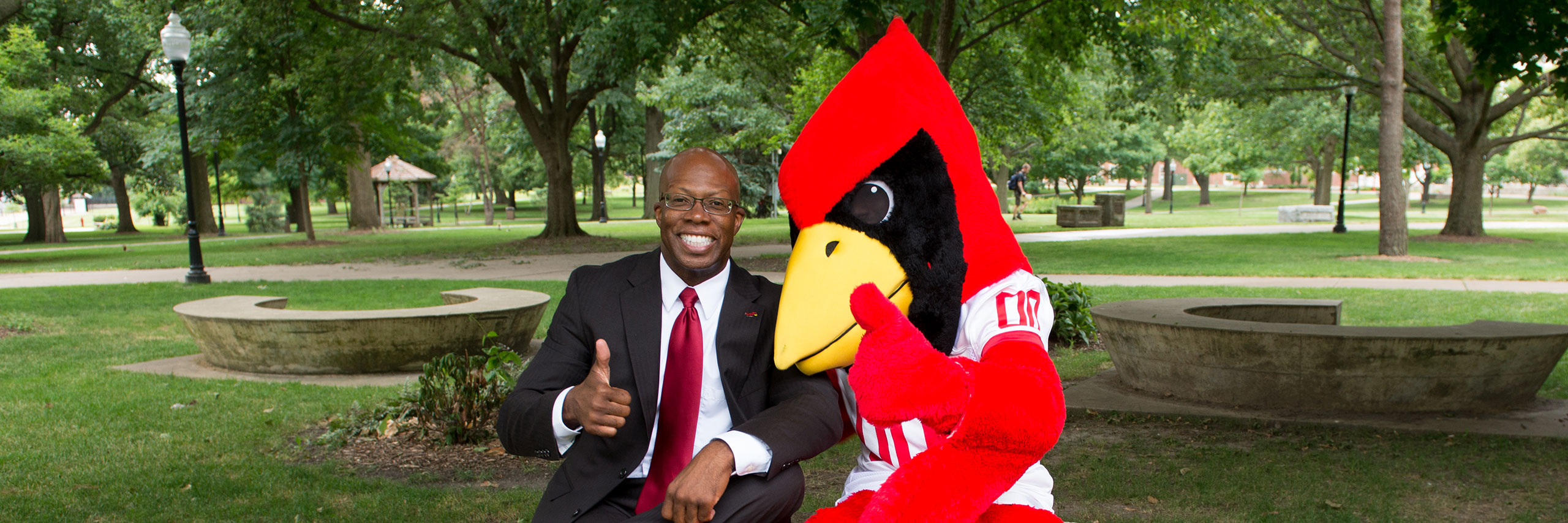 Levester Johnson ,Vice President for Student Affiars and Redbird posing.